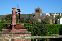 Statue of St. Bee With Priory Church, St. Bees, in the Background